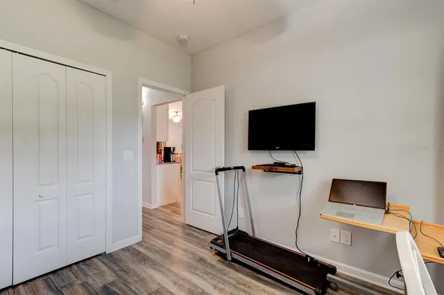 a view of workspace with wooden floor and flat screen tv