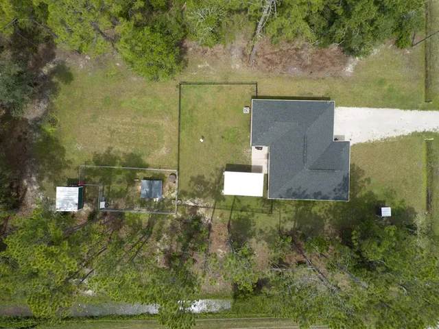 an aerial view of residential house with outdoor space