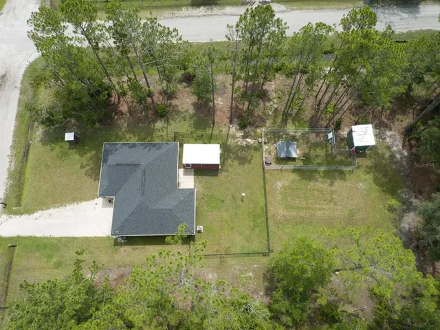an aerial view of residential house with outdoor space