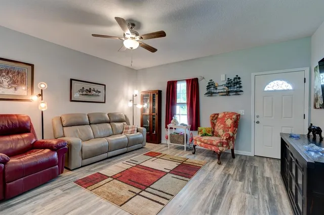 a living room with furniture and wooden floor