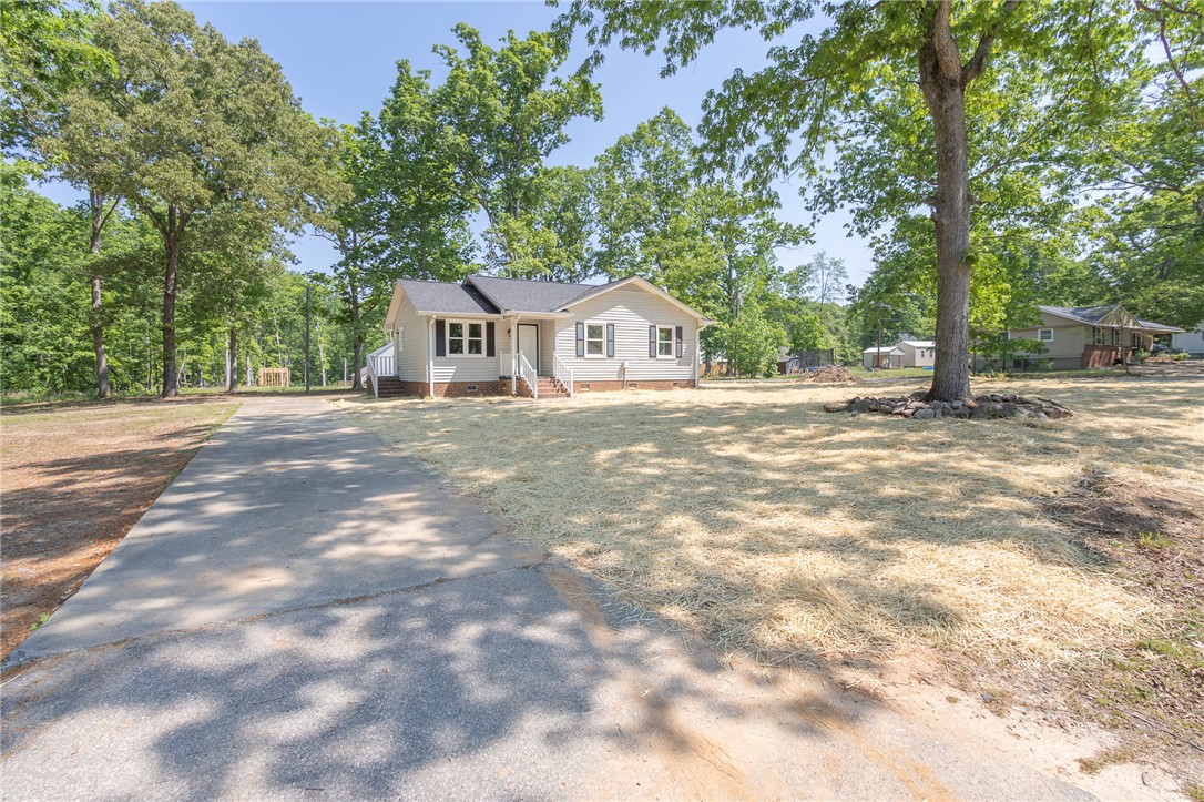 113 Linda Lane Honea Path, SC 29654 - Photo 2 of 36 This charming home features a classic ranch-style architecture amidst a serene, treed setting.
