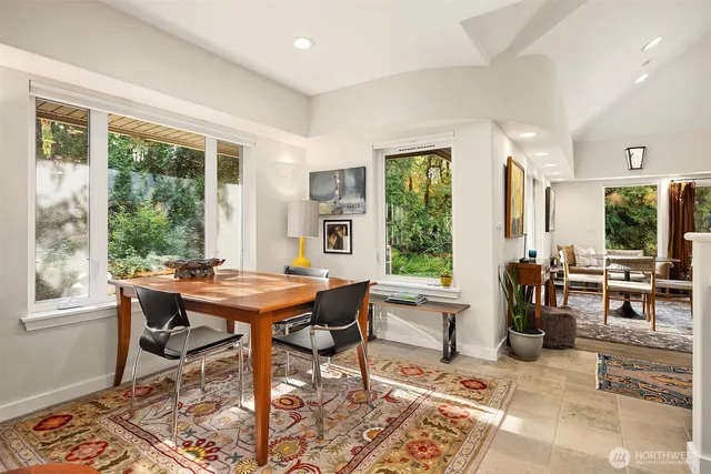 a large white kitchen with a large window and counter space