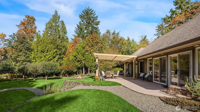a view of an house with backyard space and garden