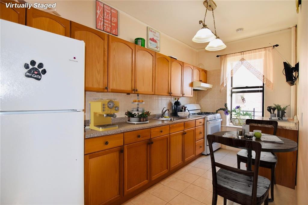 2940 Ocean Avenue, Unit A9 Brooklyn, NY 11235 - Photo 3 of 9 a kitchen with cabinets a sink appliances and a counter top space