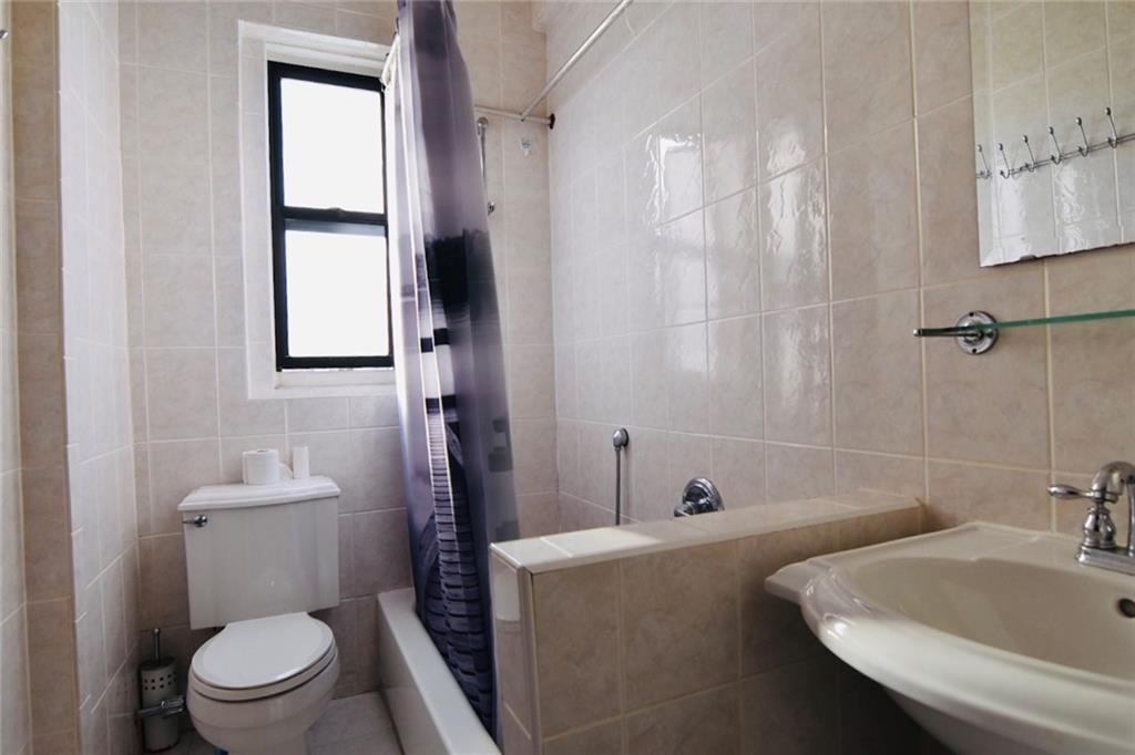 2940 Ocean Avenue, Unit A9 Brooklyn, NY 11235 - Photo 5 of 9 a bathroom with a sink a toilet and shower