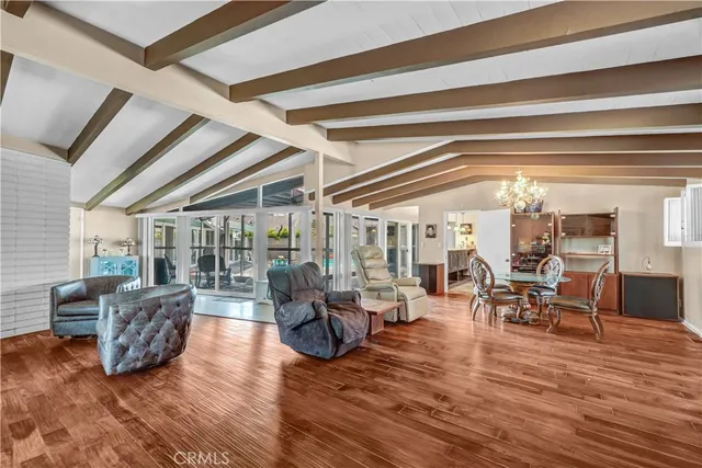 a living room with fireplace furniture and a large window