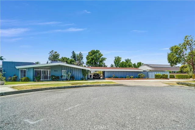 a view of a house with a yard and plants