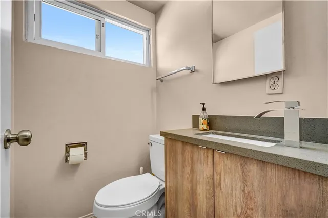 a bathroom with a sink a toilet and vanity