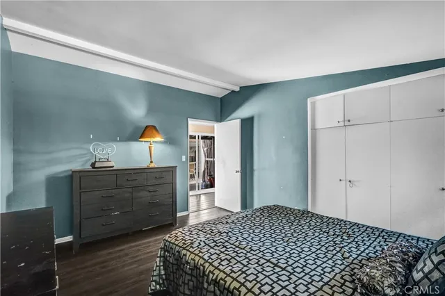 a bedroom with a bed and cabinets