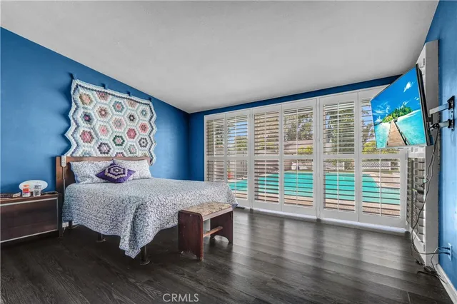 a bedroom with a bed and a large window