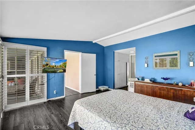 a bedroom with a bed and a large dresser in it