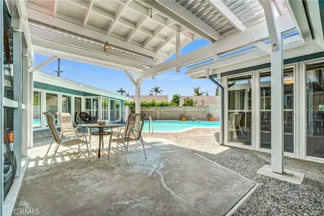 a view of a porch with a table and chairs