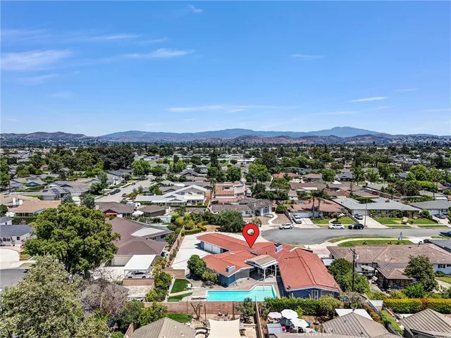 an aerial view of a city and mountain view in back