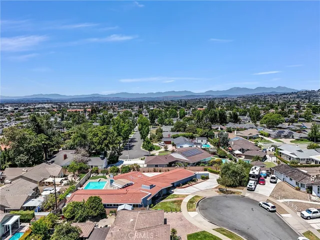 an aerial view of a houses with a swimming pool