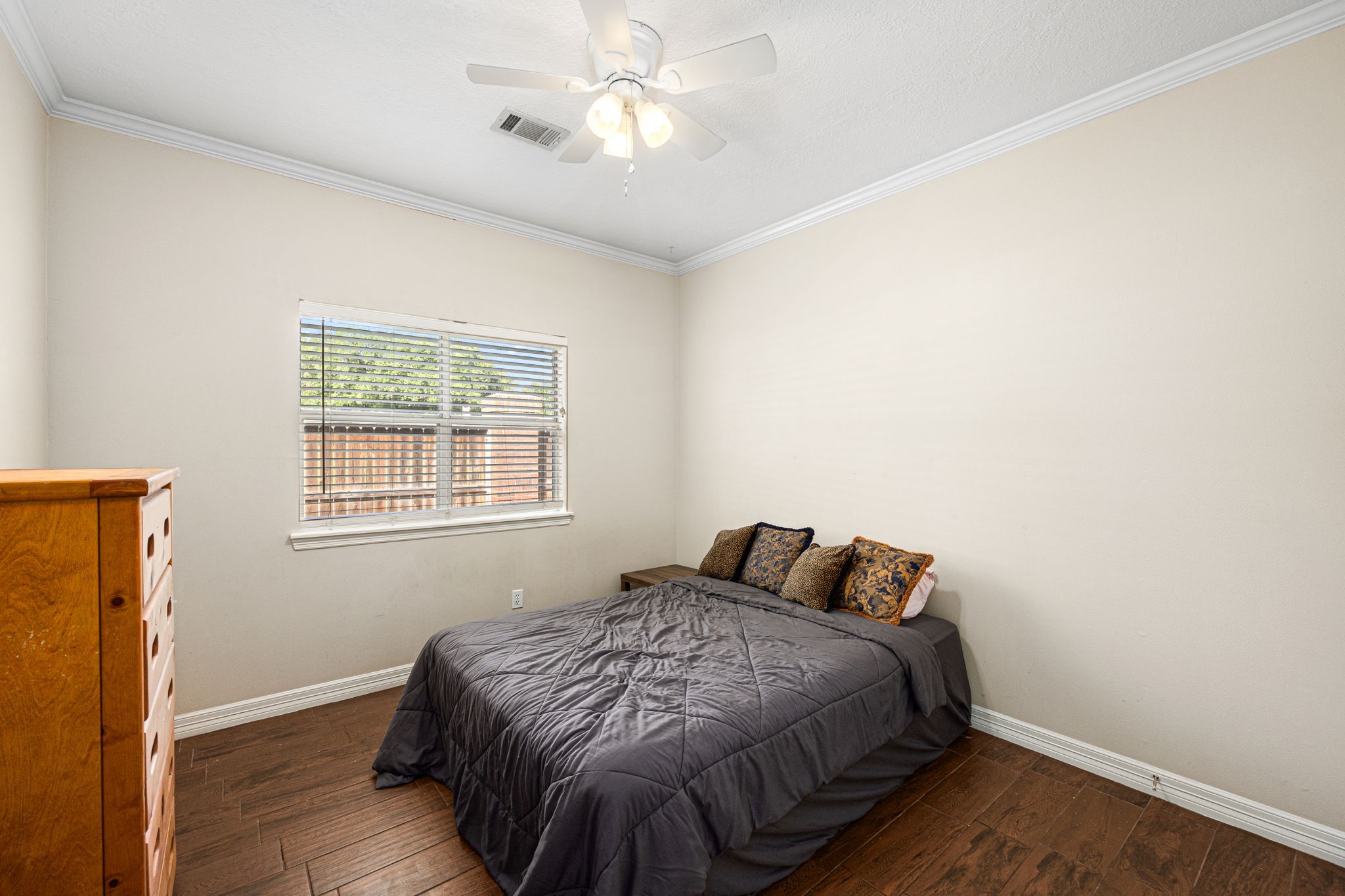 7202 North Fawn River Circle Spring, TX 77379 - Photo 19 of 23 a bedroom with a bed and wooden floor