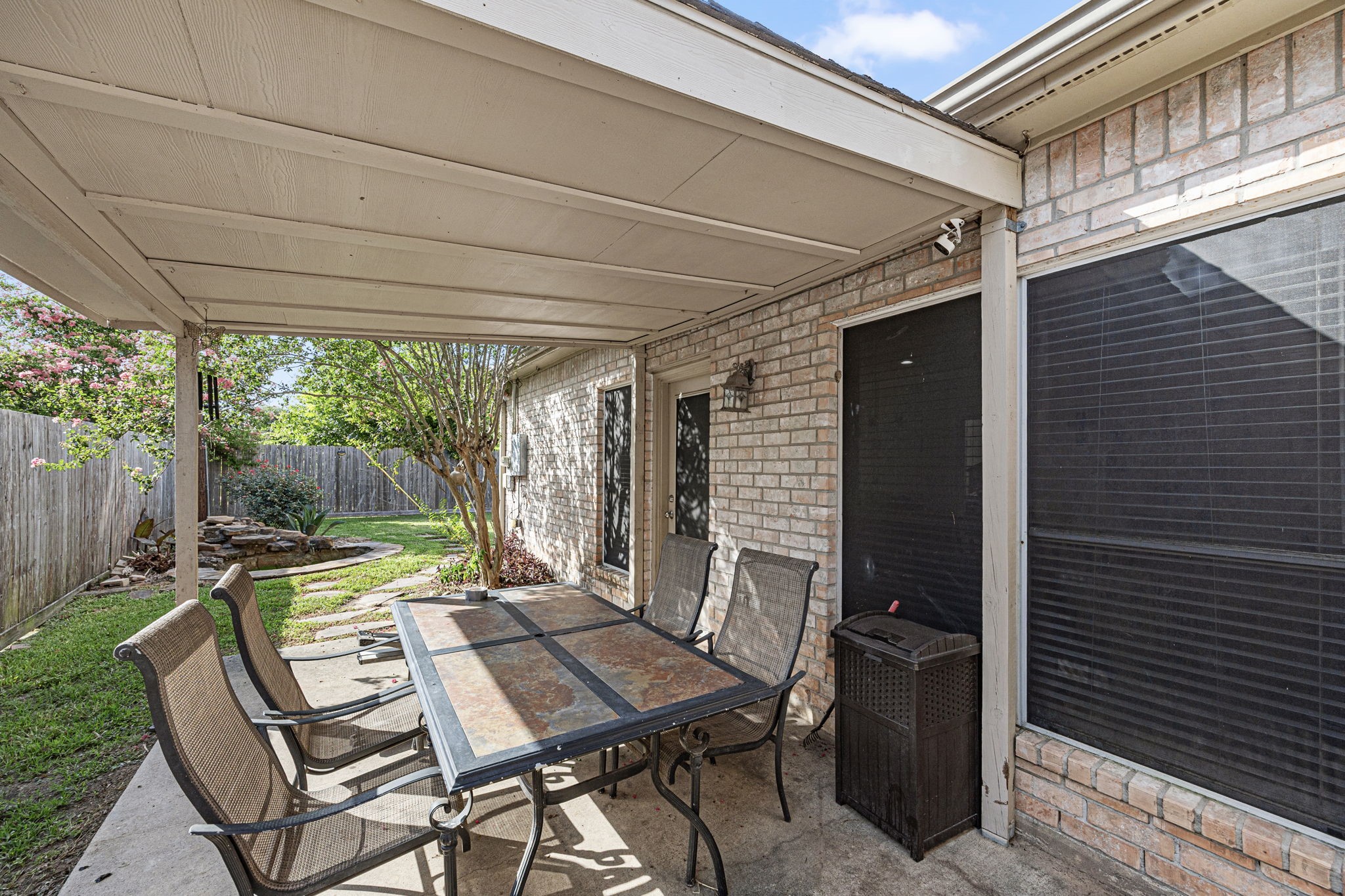 7202 North Fawn River Circle Spring, TX 77379 - Photo 21 of 23 a view of a patio with a table and chairs next to a yard