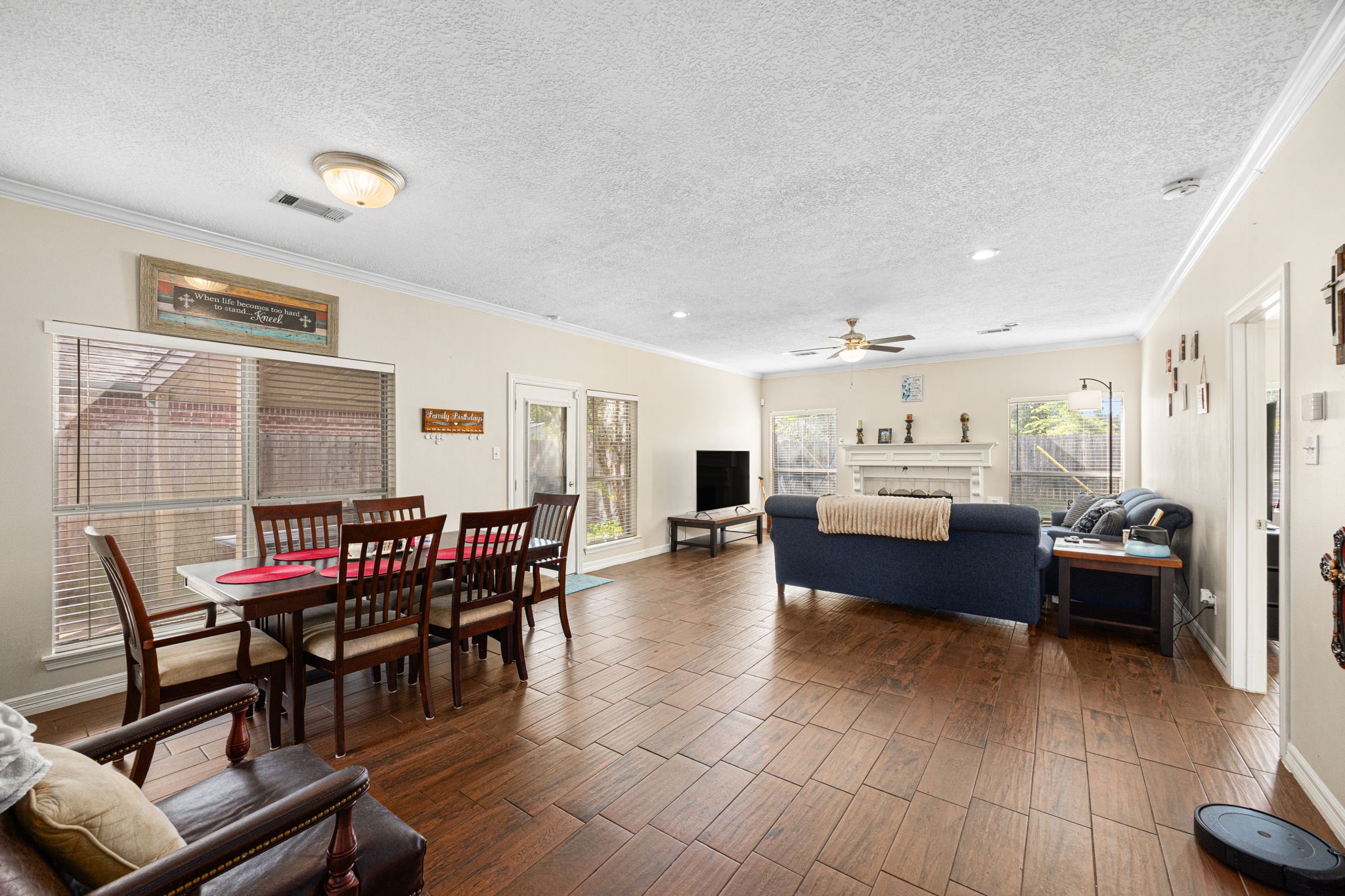 7202 North Fawn River Circle Spring, TX 77379 - Photo 6 of 23 a living room with furniture a dining table and a flat screen tv