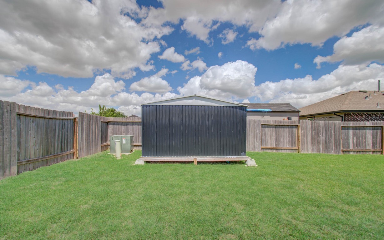 22 Desert Spring Lane Manvel, TX 77578 - Photo 39 of 39 a view of a backyard with potted plants and wooden fence