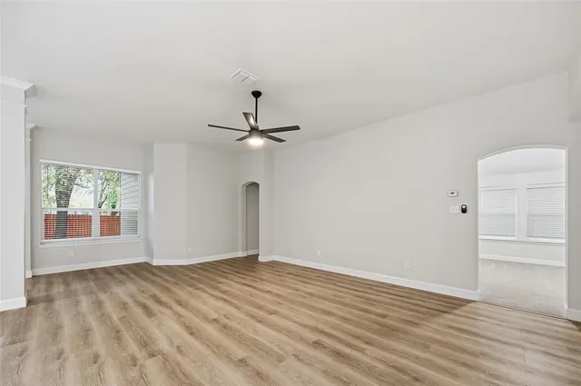 wooden floor in an empty room with a window