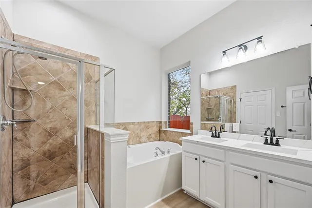a bathroom with a double vanity sink mirror and shower