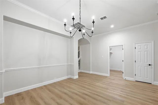a view of a room with wooden floor and ceiling fan
