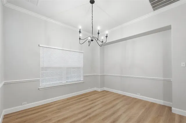 a view of a room with wooden floor and fan