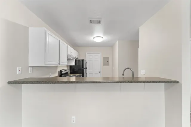 a kitchen with a stove a refrigerator and a sink