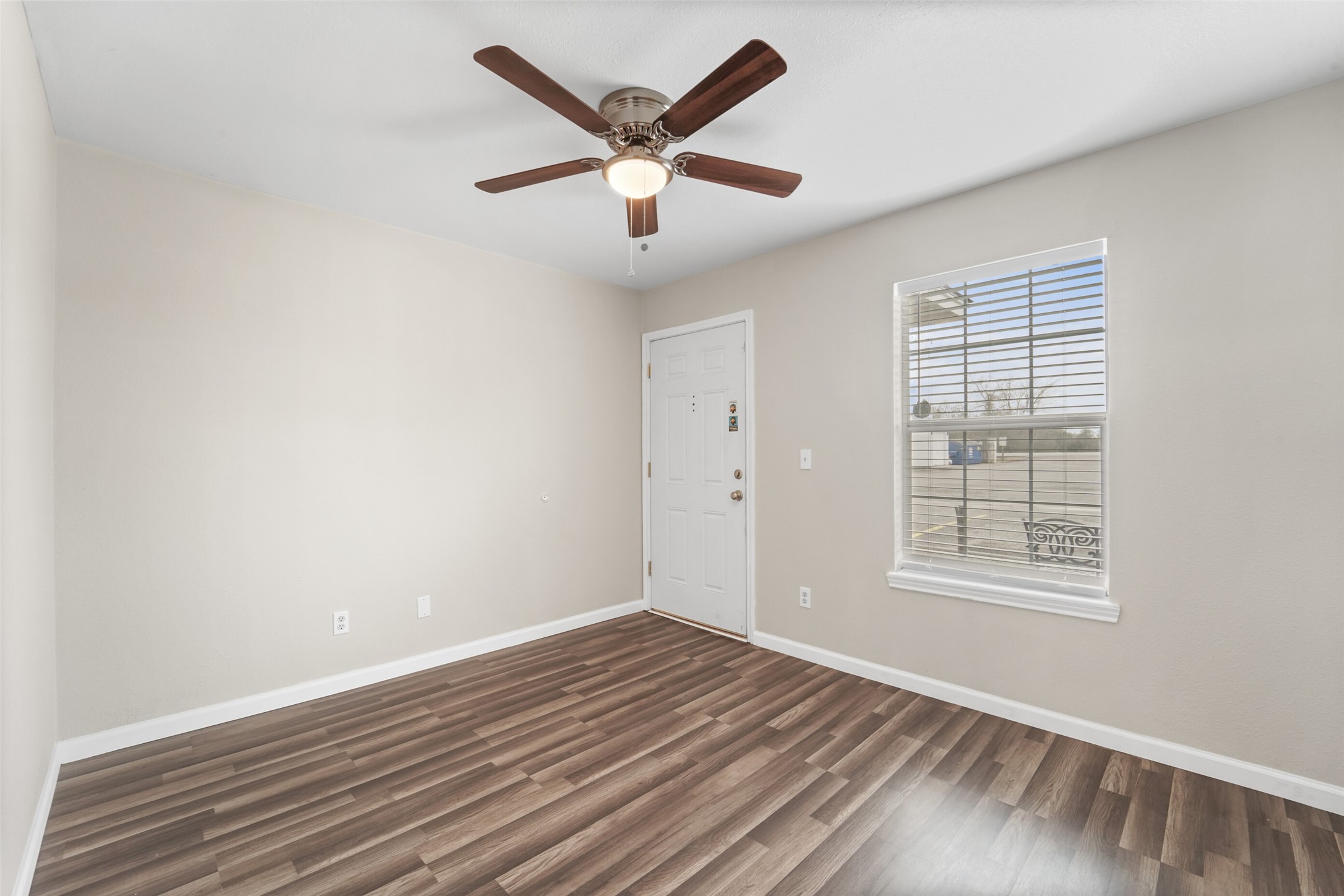 512 Hollyhock Street, Unit 24 Prairie View, TX 77484 - Photo 9 of 12 an empty room with wooden floor and windows