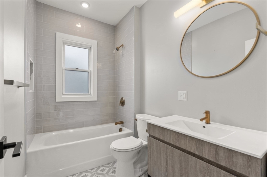 101 Draper Street, Unit 2 Boston, MA 02122 - Photo 12 of 19 a bathroom with a sink a toilet and a mirror