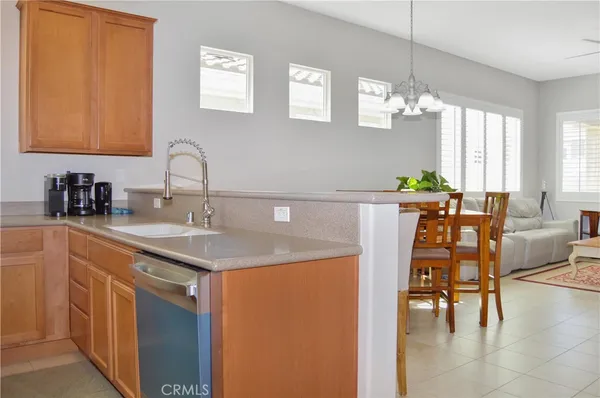 a kitchen with stainless steel appliances granite countertop a stove a refrigerator and a microwave