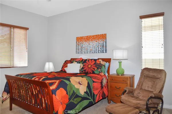 a bedroom with a bed and a flat tv screen