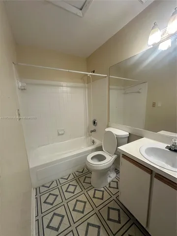 a bathroom with sink mirror and toilet
