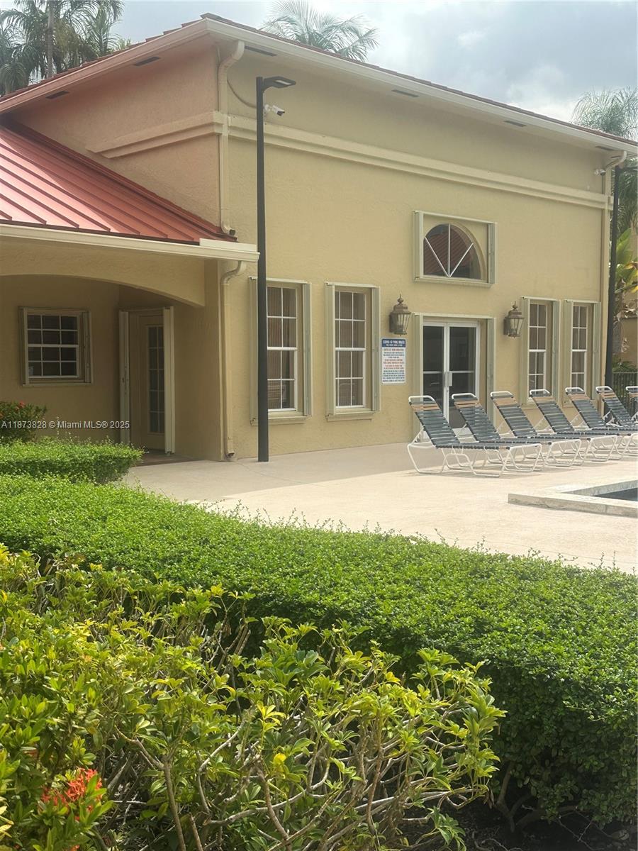 18318 Northwest 68th Avenue, Unit B Hialeah, FL 33015 - Photo 21 of 26 a view of a house with a yard