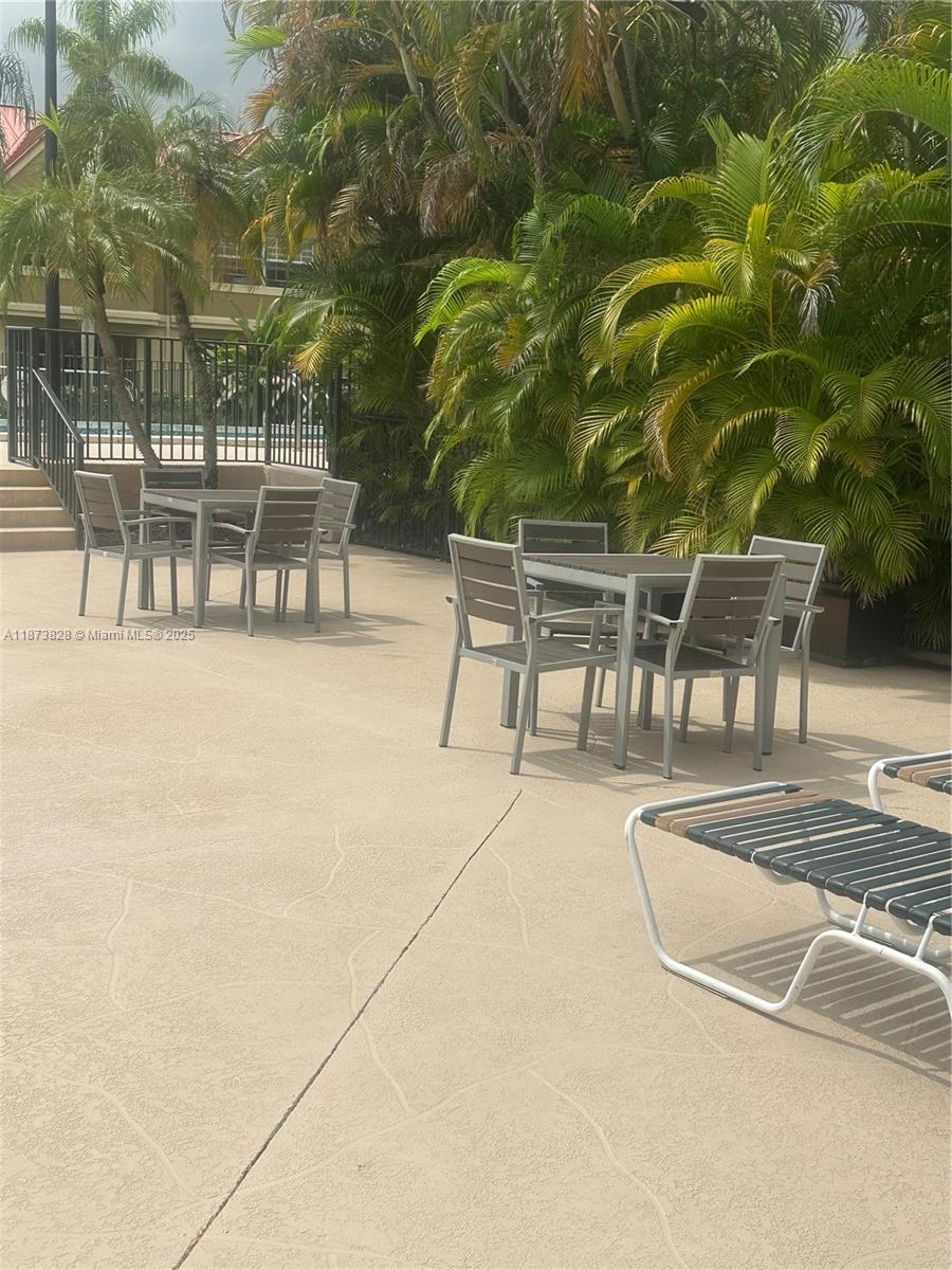18318 Northwest 68th Avenue, Unit B Hialeah, FL 33015 - Photo 22 of 26 an outdoor view with patio