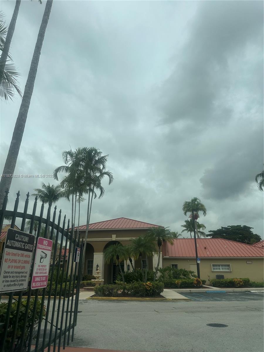 18318 Northwest 68th Avenue, Unit B Hialeah, FL 33015 - Photo 23 of 26 a front view of a house with a garden