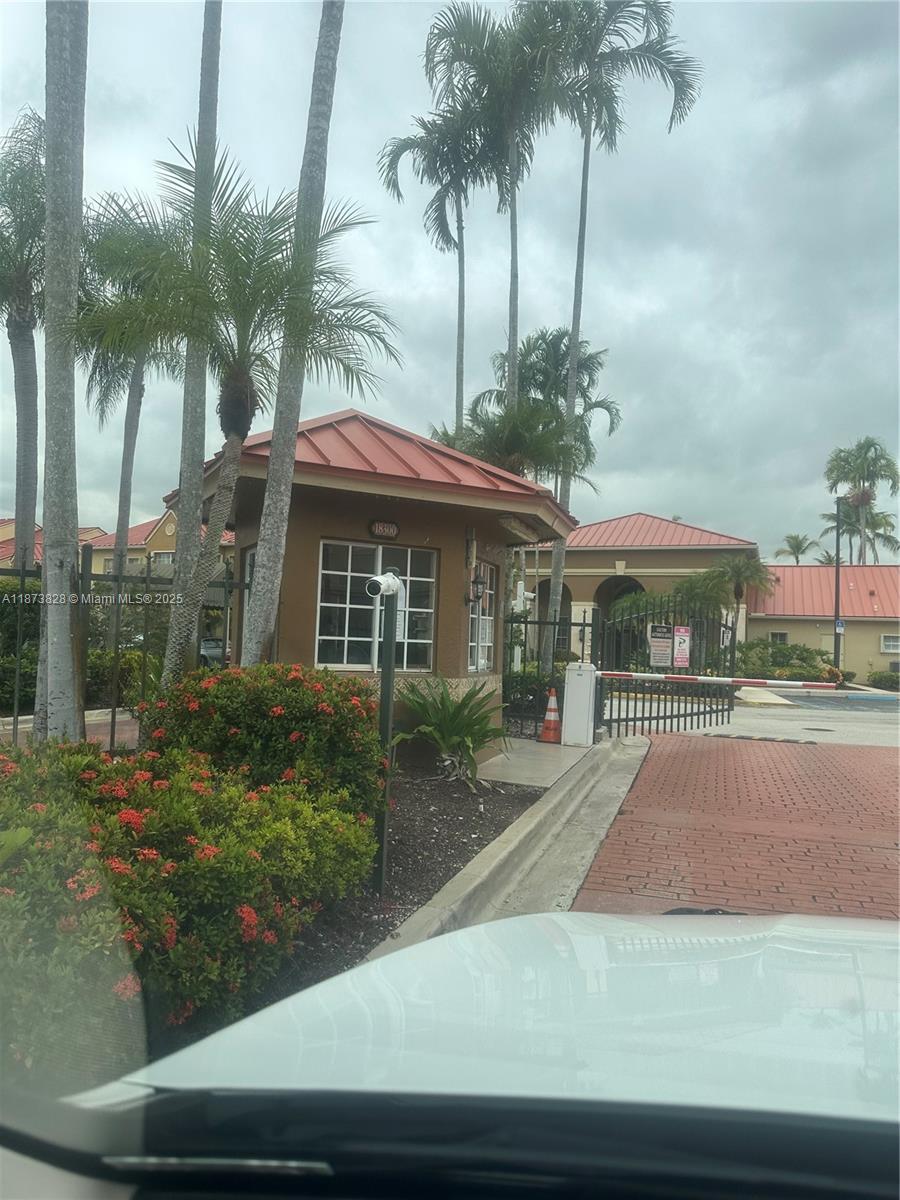 18318 Northwest 68th Avenue, Unit B Hialeah, FL 33015 - Photo 25 of 26 a front view of house with yard and green space