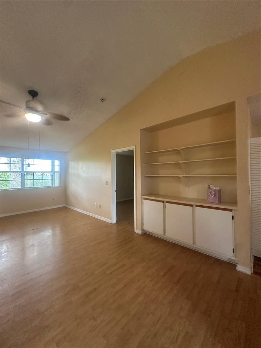 18318 Northwest 68th Avenue, Unit B Hialeah, FL 33015 - Photo 6 of 26 a view of an empty room and window