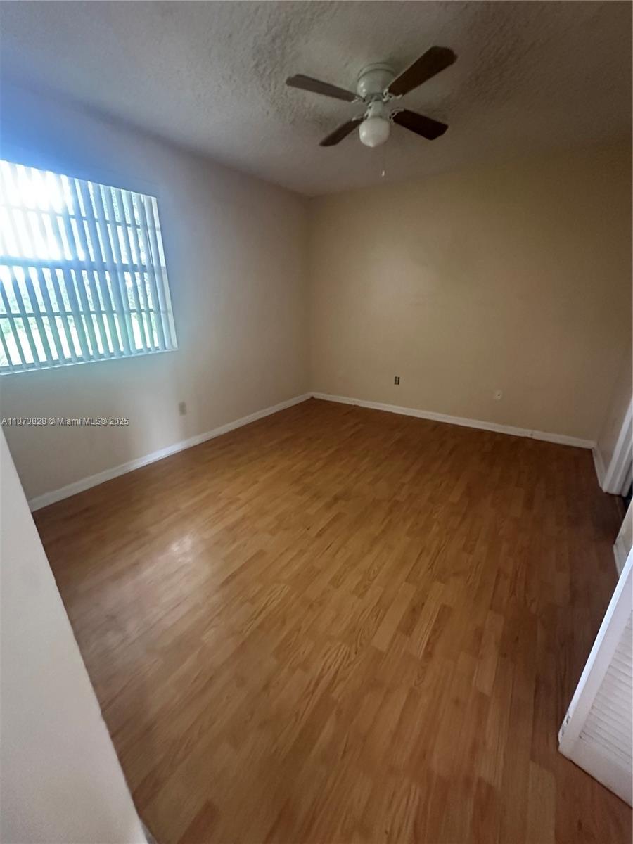 18318 Northwest 68th Avenue, Unit B Hialeah, FL 33015 - Photo 7 of 26 an empty room with a window