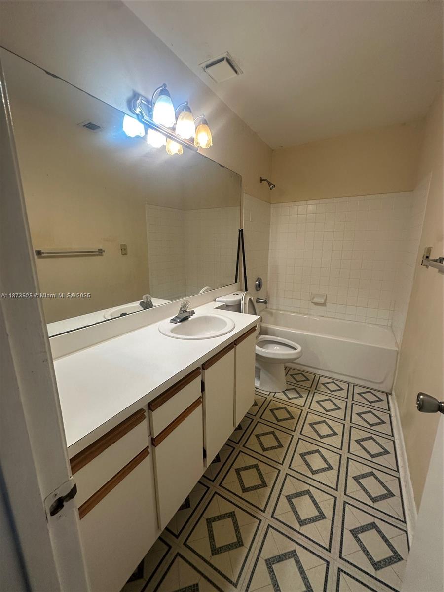 18318 Northwest 68th Avenue, Unit B Hialeah, FL 33015 - Photo 9 of 26 a bathroom with a sink and a mirror