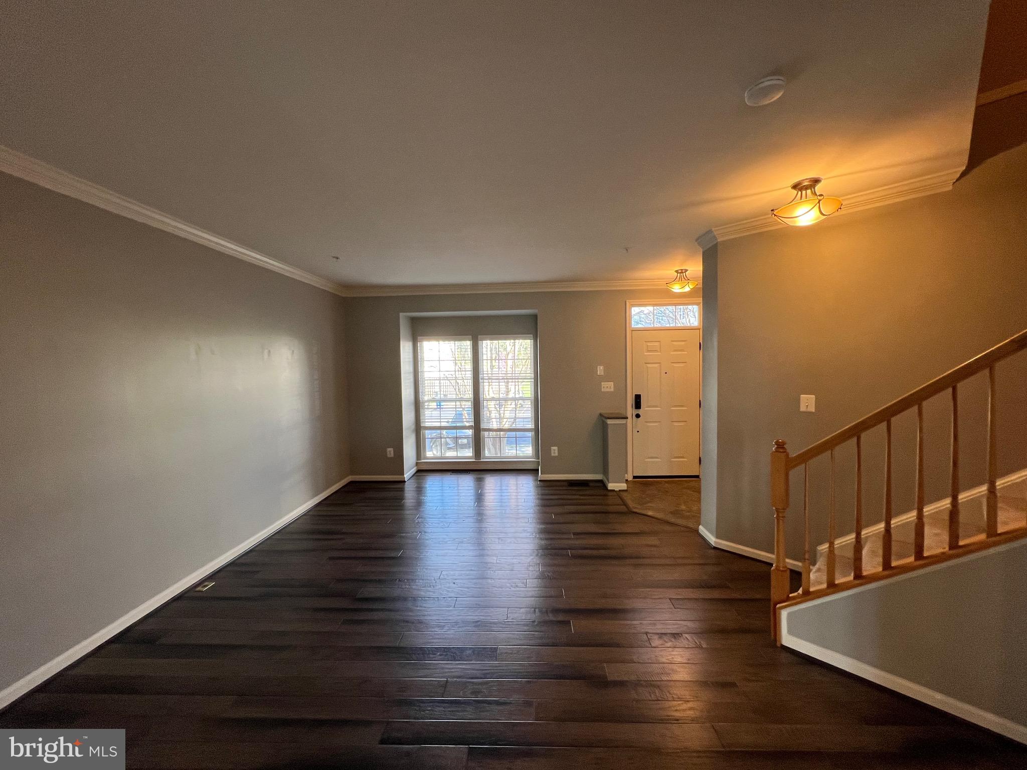 131 Fiona Way Brunswick, MD 21758 - Photo 12 of 73 a view of an empty room with wooden floor and a window