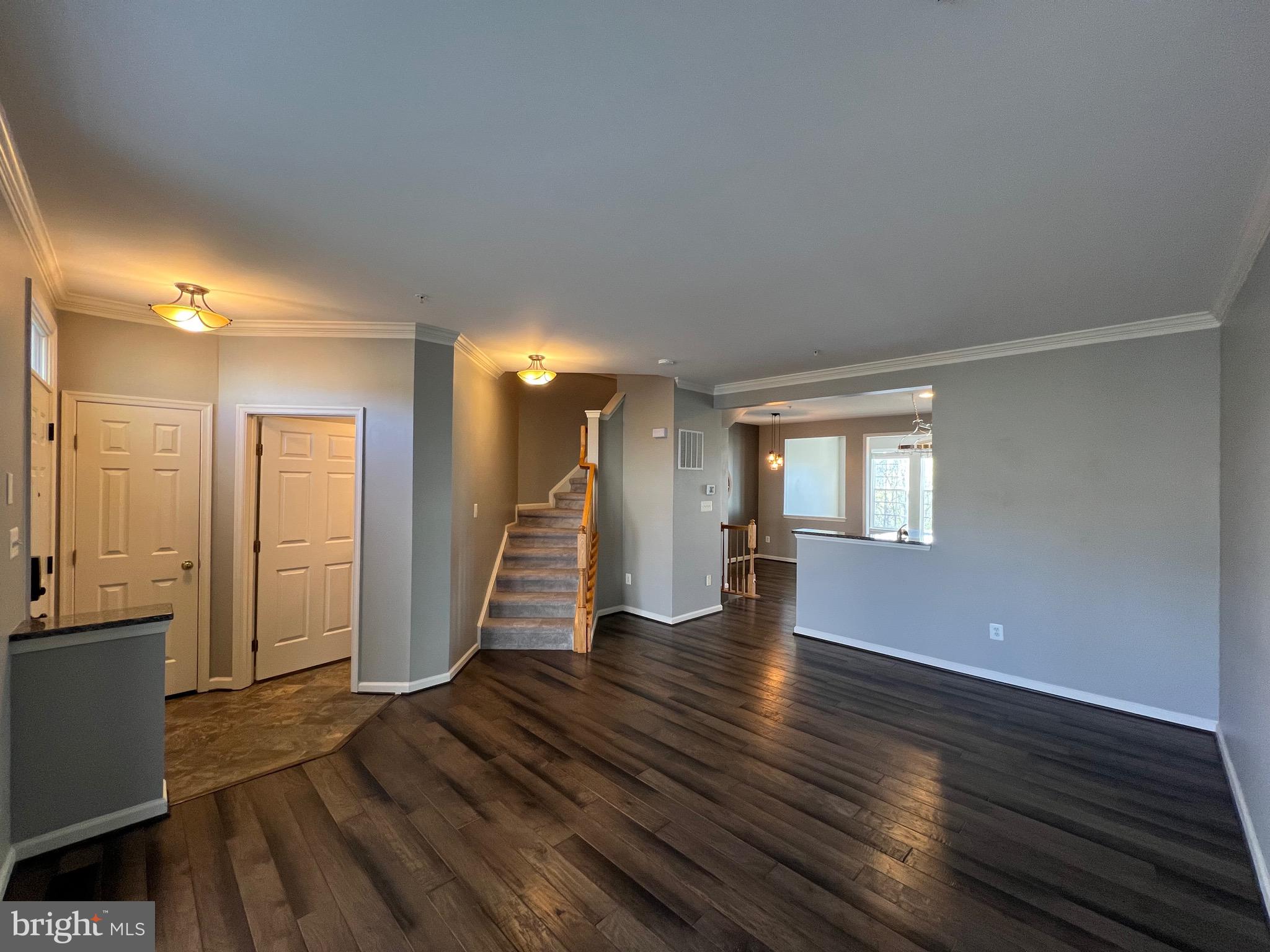 131 Fiona Way Brunswick, MD 21758 - Photo 14 of 73 a view of an empty room with wooden floor and a window