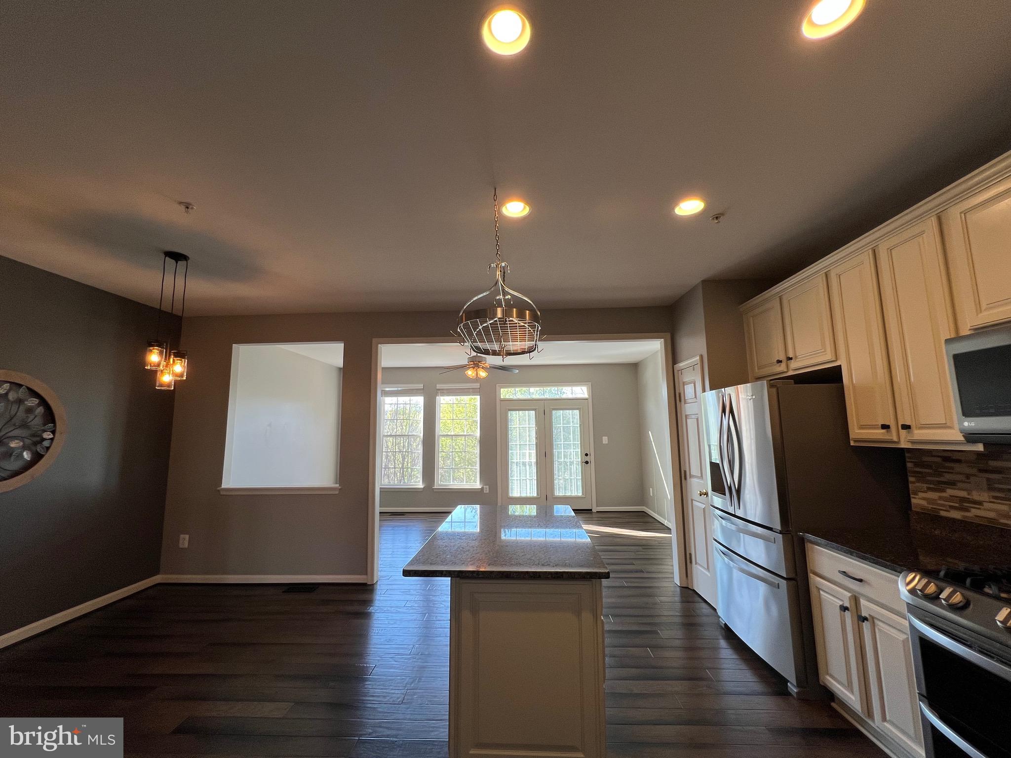 131 Fiona Way Brunswick, MD 21758 - Photo 25 of 73 a kitchen with stainless steel appliances granite countertop a refrigerator a stove and a wooden floors