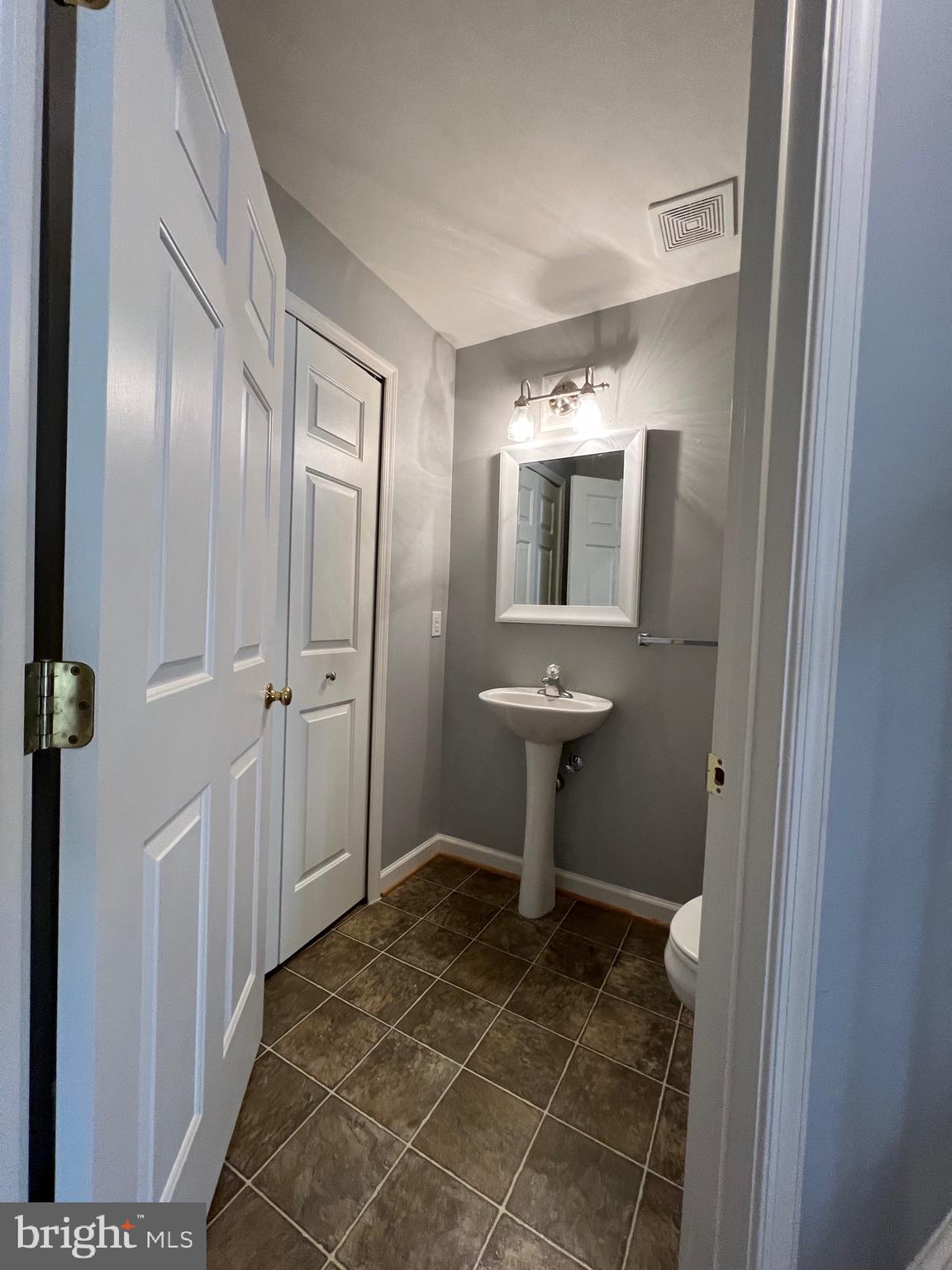 131 Fiona Way Brunswick, MD 21758 - Photo 37 of 73 a view of a bathroom with a sink and mirror