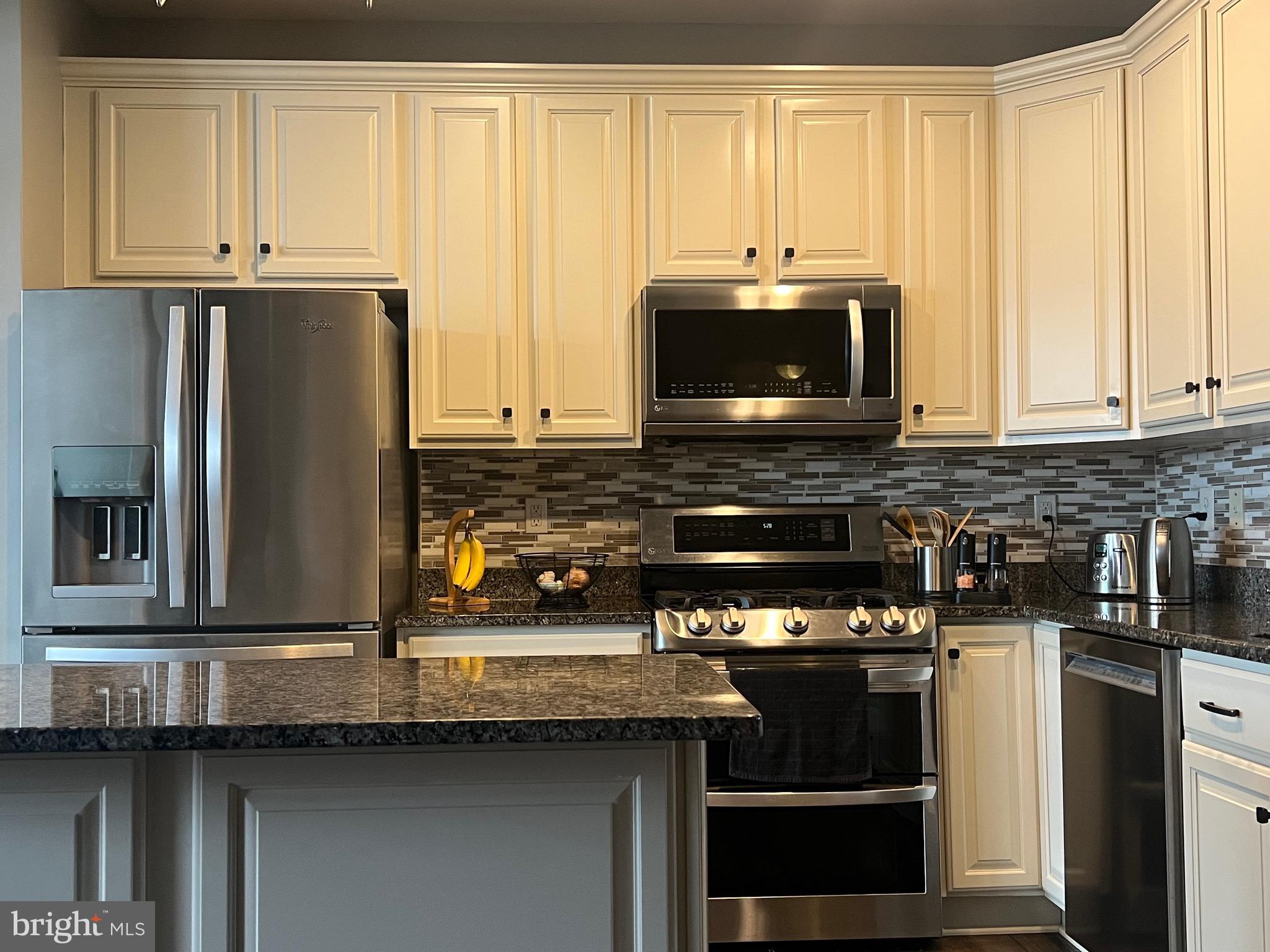 131 Fiona Way Brunswick, MD 21758 - Photo 5 of 73 a kitchen with stainless steel appliances a stove a microwave and a sink