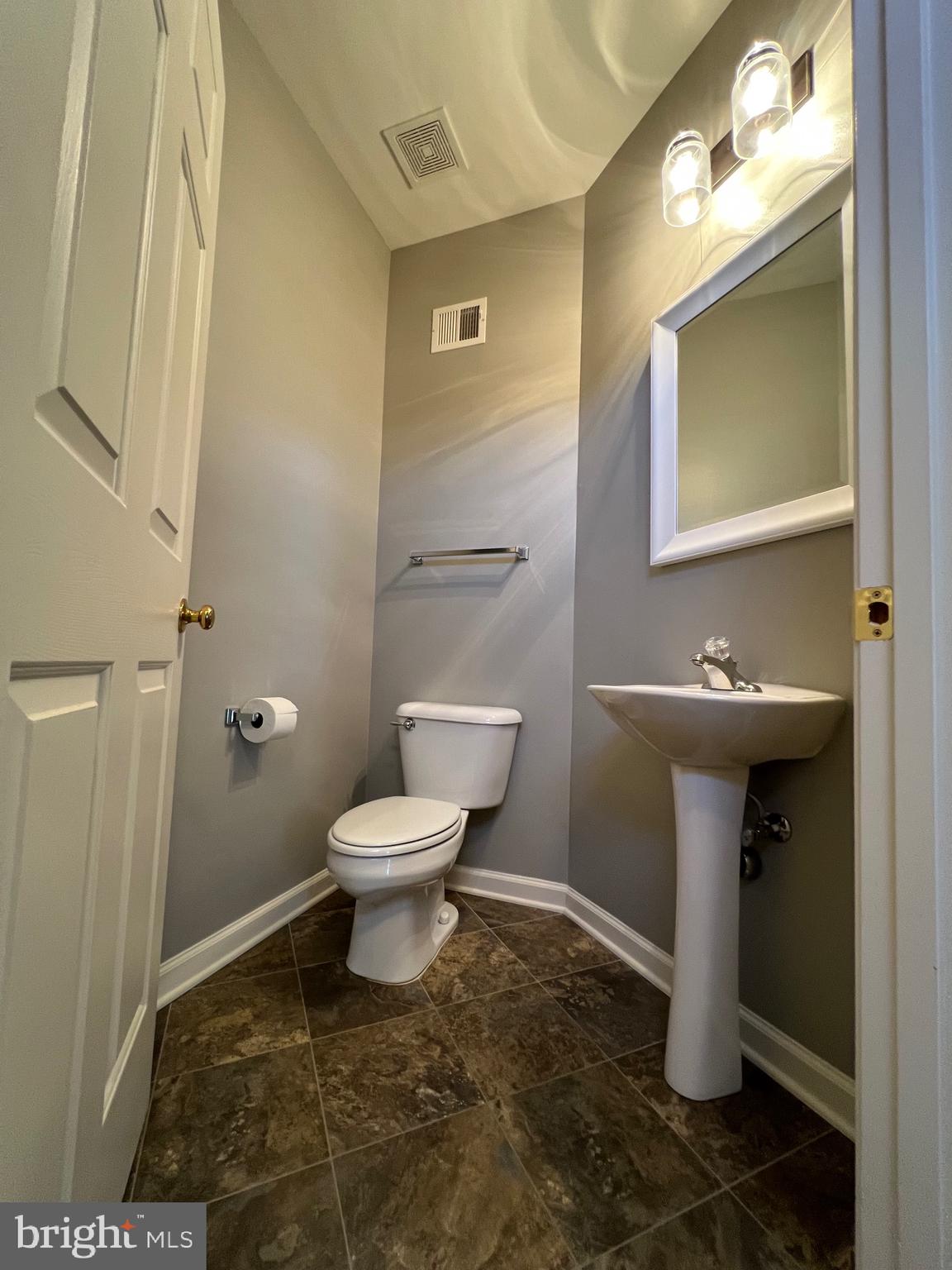 131 Fiona Way Brunswick, MD 21758 - Photo 8 of 73 a bathroom with a toilet sink and mirror