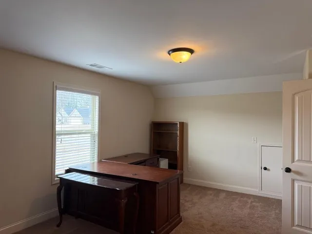 a view of a workspace with furniture