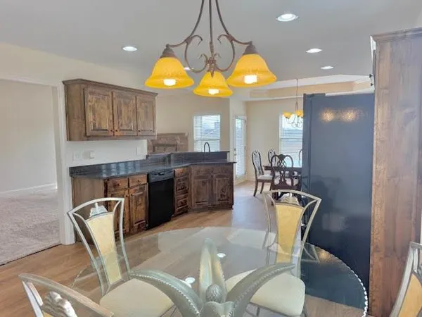 a view of a dining room with furniture and a chandelier