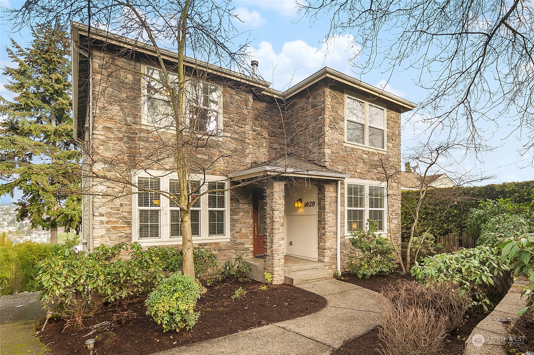 a front view of a house with a garden