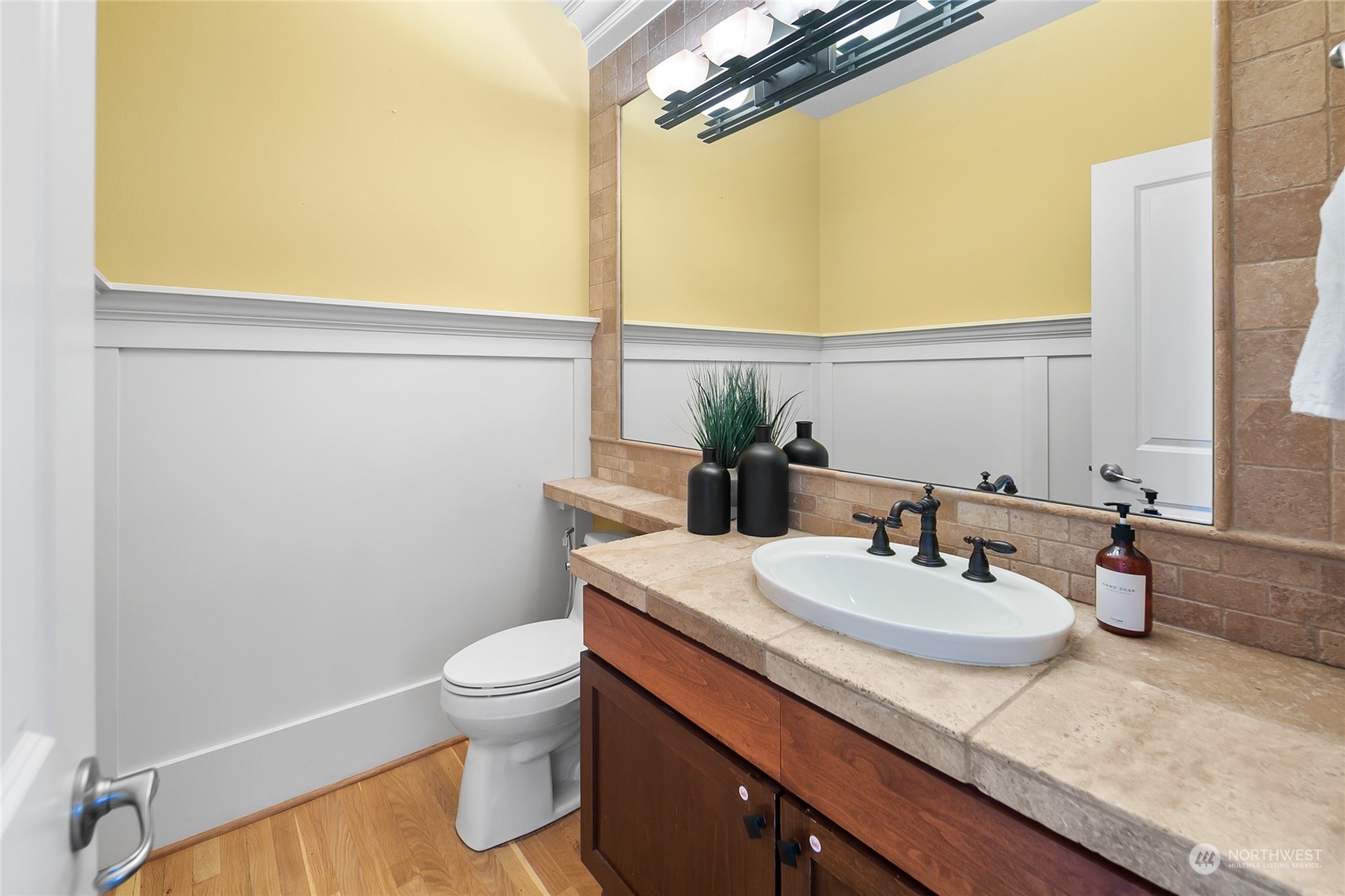 1020 West Ruffner Street Seattle, WA 98119 - Photo 16 of 39 a bathroom with a granite countertop sink a toilet and a mirror