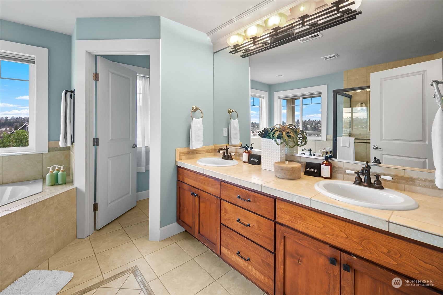 1020 West Ruffner Street Seattle, WA 98119 - Photo 21 of 39 a spacious en suite bathroom with double sink and a mirror